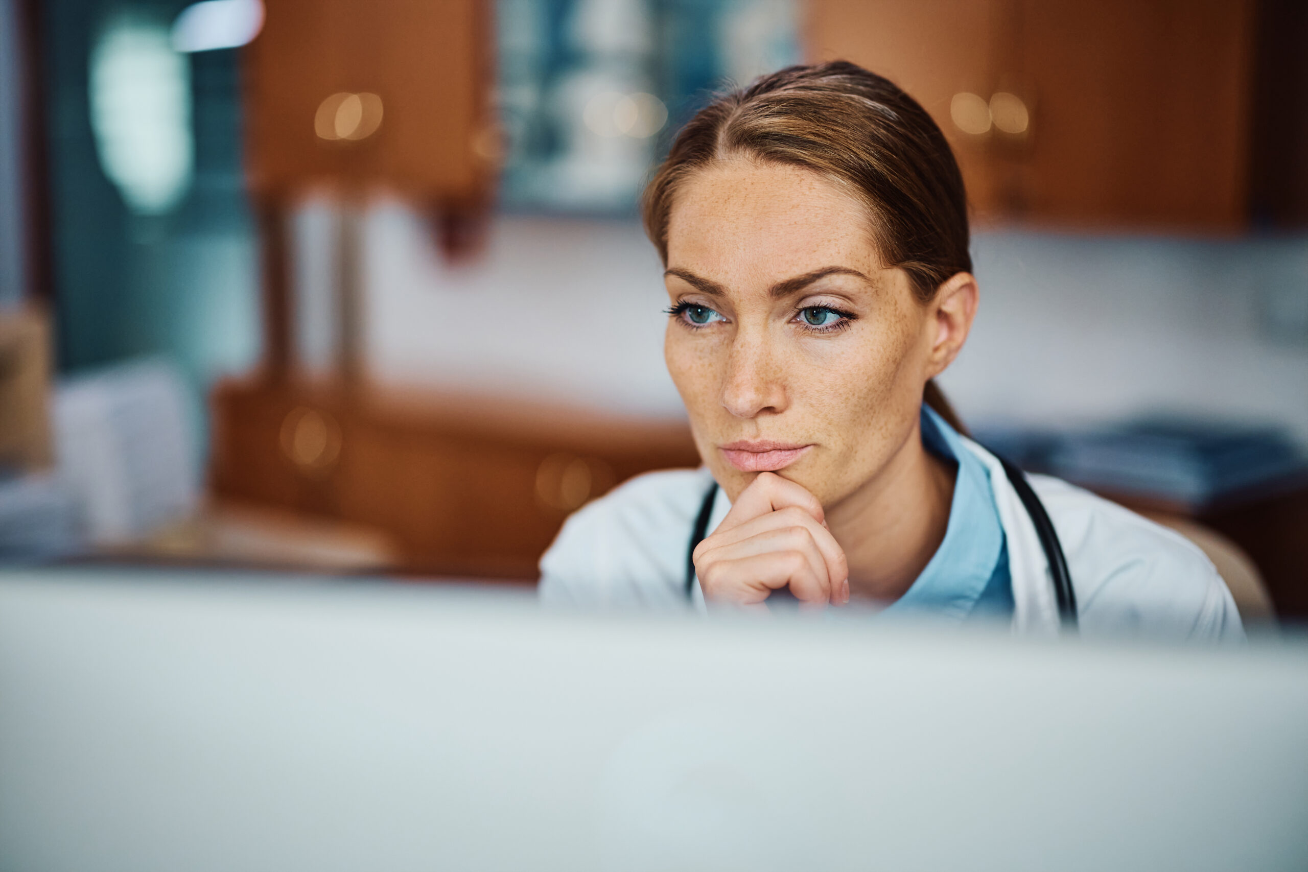 pensive doctor working on her desktop pc at doctor 2023 11 27 05 06 04 utc scaled